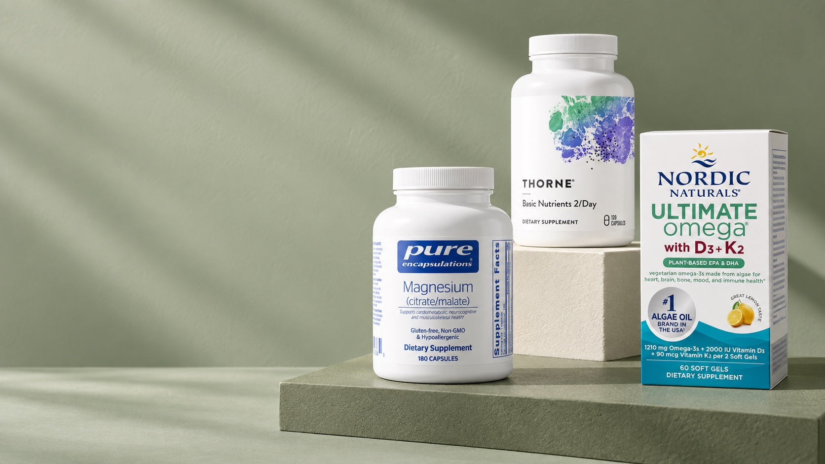Thorne, Pure Encapsulations, and Nordic Naturals products on sculptural sage plinths